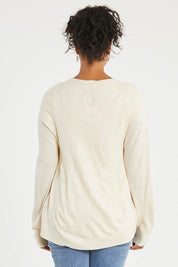 Model Noli wearing size L of The Keepers Soft Button Up Cardigan in colour Ivory (White), from the back