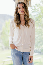 Model Tahlia wearing size S of The Keepers Soft Button Up Cardigan in colour Ivory (White), from the front, showing the whole outfit