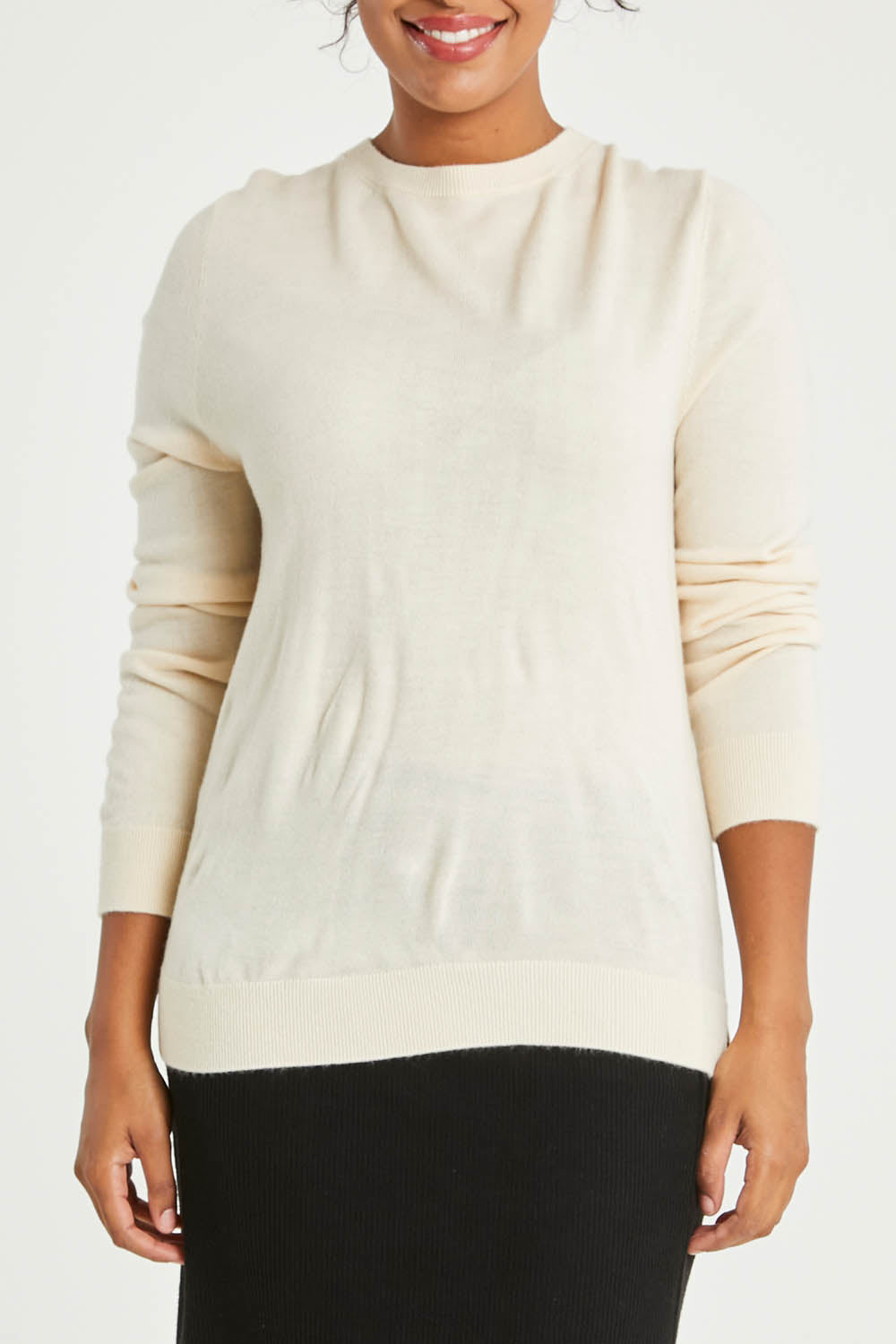 Model Noli wearing size L of The Keepers Soft Round Neck Jumper in colour Ivory (White), from the front, cropped image
