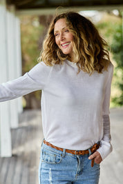 Model Emma wearing size S of The Keepers Soft Round Neck Jumper in colour Snow (White), from the front, showing the whole outfit