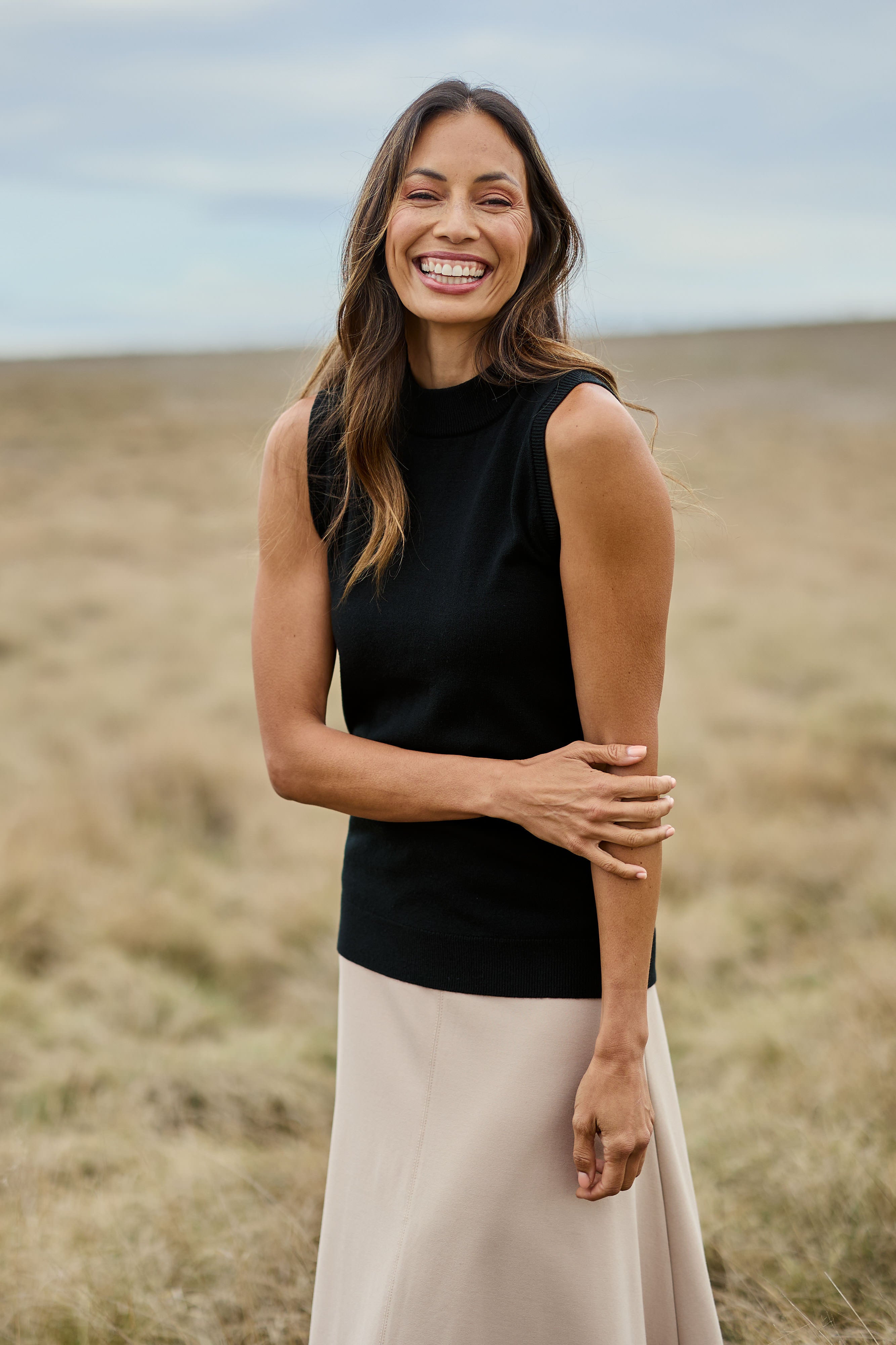 Model Amanda wearing size S of The Soft Sleeveless Mockturtle Jumper in colour Black (Black), from the front, showing the whole outfit
