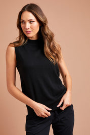 Model Madeline wearing size S of The Soft Sleeveless Mockturtle Jumper in colour Black (Black), from the front, showing the whole outfit