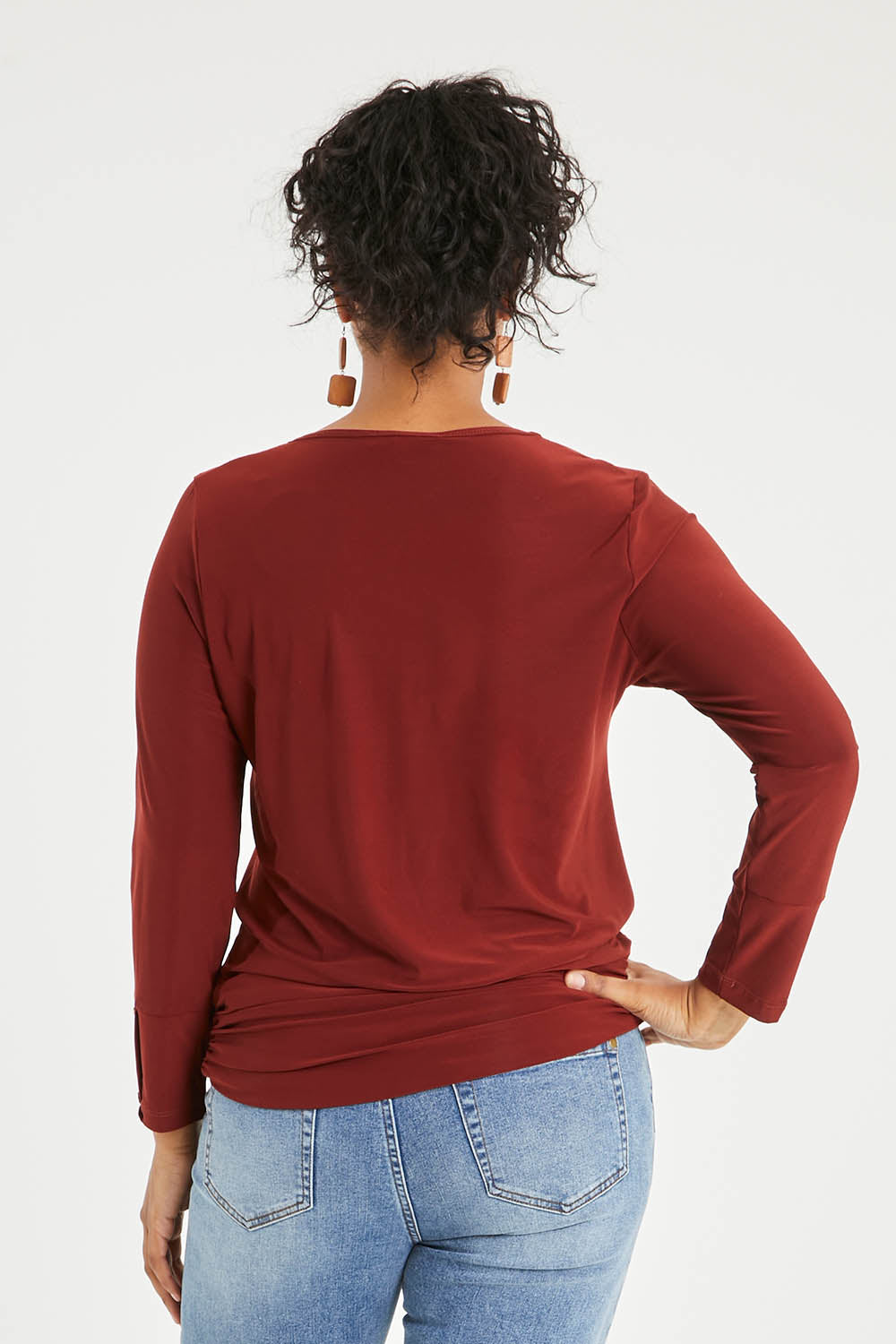 Model Noli wearing size 14 of The Recycled V Neck L/S Tee in colour Terracotta, from the back