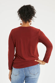 Model Noli wearing size 14 of The Recycled V Neck L/S Tee in colour Terracotta, from the back