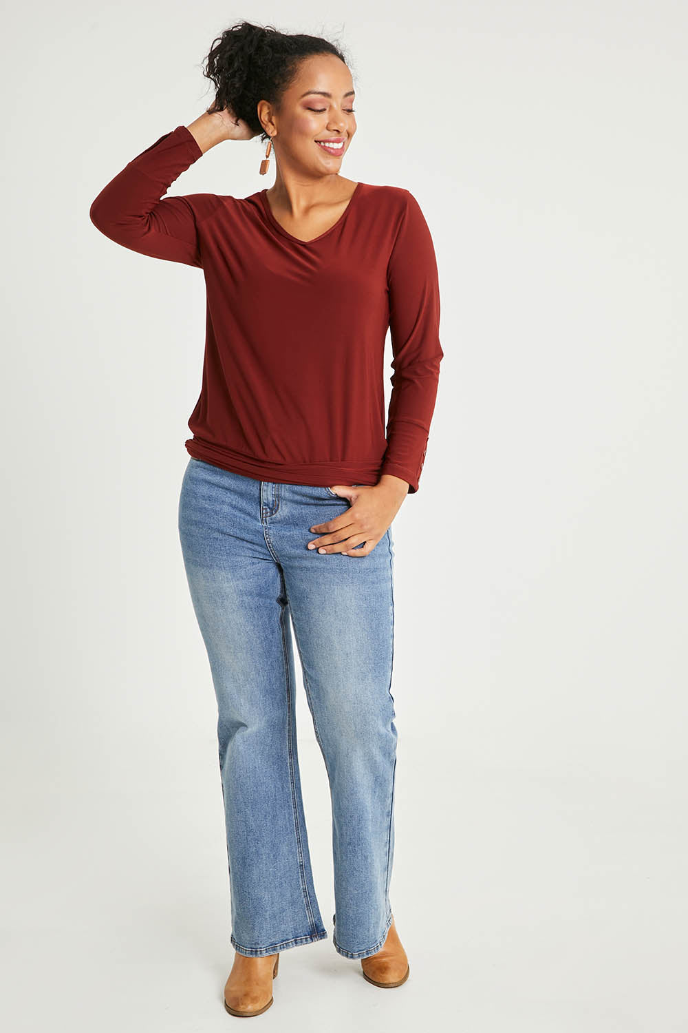 Model Noli wearing size 14 of The Recycled V Neck L/S Tee in colour Terracotta, from the front, showing the whole outfit