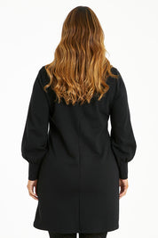 Model Laura wearing size 14 of The Keepers Classic Ponte Dress in colour Black (Black), from the back