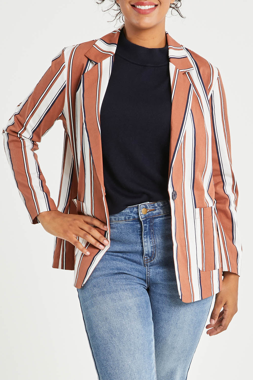 Model Noli wearing size 14 of The Classic Stripe Blazer in colour Navyrust (Blue), from the front, cropped image