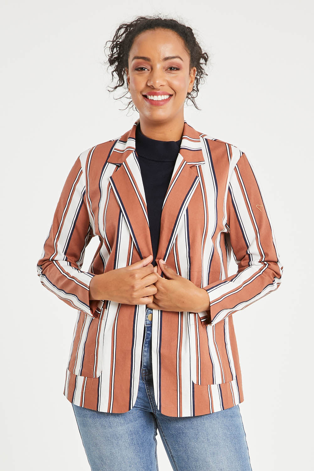 Model Noli wearing size 14 of The Classic Stripe Blazer in colour Navyrust (Blue), from the front, cropped image