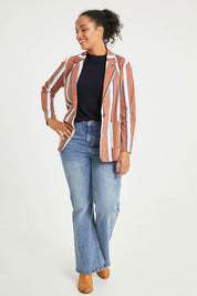 Model Noli wearing size 14 of The Classic Stripe Blazer in colour Navyrust (Blue), from the front, showing the whole outfit