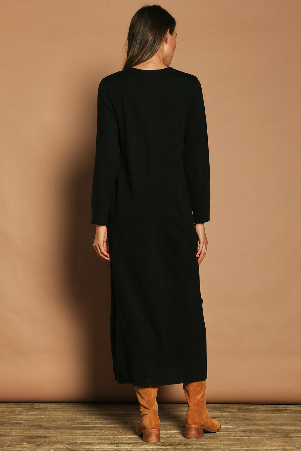 Model Madeline wearing size S of The Keepers Soft Knit Maxi Dress in colour Black (Black), from the back