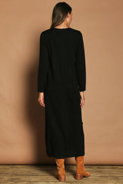 Model Madeline wearing size S of The Keepers Soft Knit Maxi Dress in colour Black (Black), from the back