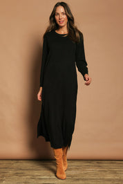 Model Madeline wearing size S of The Keepers Soft Knit Maxi Dress in colour Black (Black), from the front, showing the whole outfit
