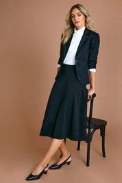 Model Alice wearing size 10 of The Fit And Flare Ponte Skirt in colour Black (Black), from the front, showing the whole outfit
