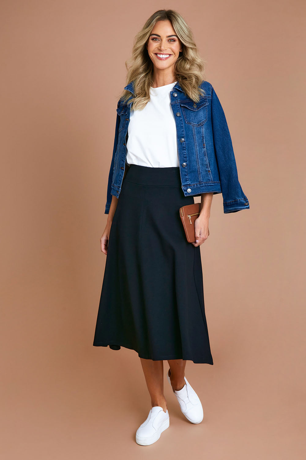 Model Alice wearing size 10 of The Fit And Flare Ponte Skirt in colour Black (Black), from the front, showing the whole outfit