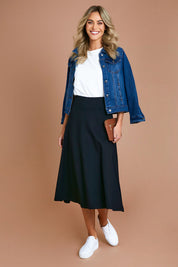 Model Alice wearing size 10 of The Fit And Flare Ponte Skirt in colour Black (Black), from the front, showing the whole outfit