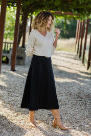 Model Emma wearing size 10 of The Fit And Flare Ponte Skirt in colour Black (Black), from the front, showing the whole outfit
