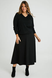 Model Laura wearing size 14 of The Fit And Flare Ponte Skirt in colour Black (Black), from the front, showing the whole outfit