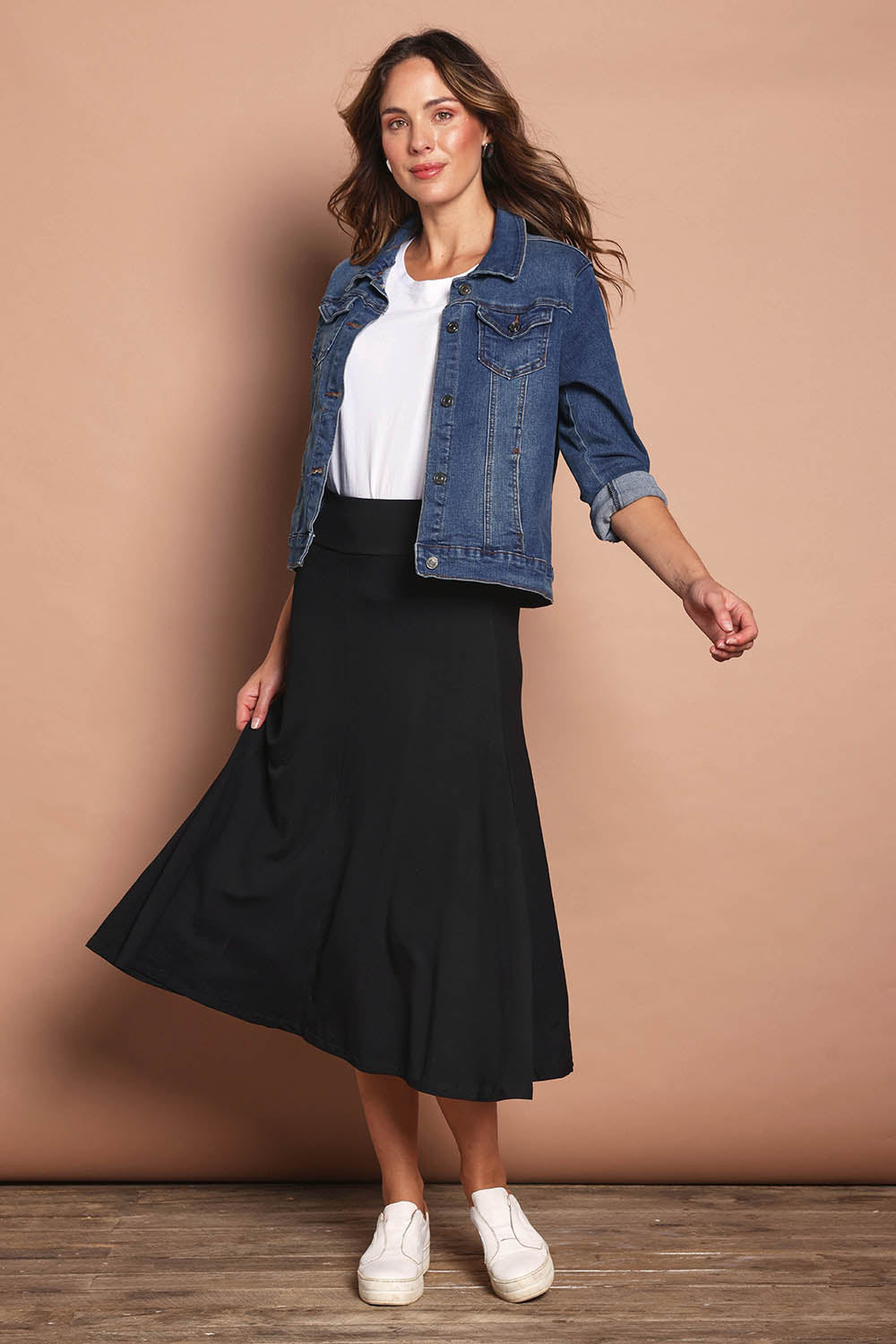 Model Madeline wearing size 10 of The Fit And Flare Ponte Skirt in colour Black (Black), from the front, showing the whole outfit