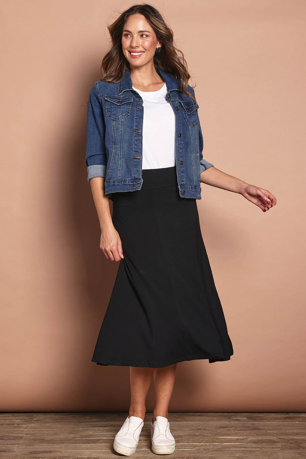 Model Madeline wearing size 10 of The Fit And Flare Ponte Skirt in colour Black (Black), from the front, showing the whole outfit