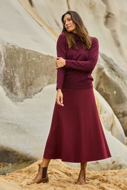 Model Amanda wearing size 10 of The Fit And Flare Ponte Skirt in colour Cognac (Red), from the front, showing the whole outfit