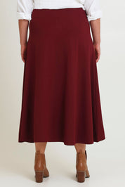 Model Chanel wearing size 16 of The Fit And Flare Ponte Skirt in colour Cognac (Red), from the back