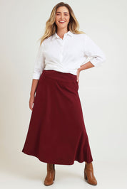Model Chanel wearing size 16 of The Fit And Flare Ponte Skirt in colour Cognac (Red), from the front, showing the whole outfit