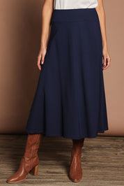 Model Madeline wearing size 10 of The Fit And Flare Ponte Skirt in colour Frenchnavy (Blue), from the front, cropped image