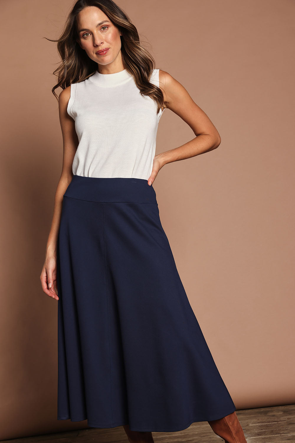 Model Madeline wearing size 10 of The Fit And Flare Ponte Skirt in colour Frenchnavy (Blue), from the front, cropped image