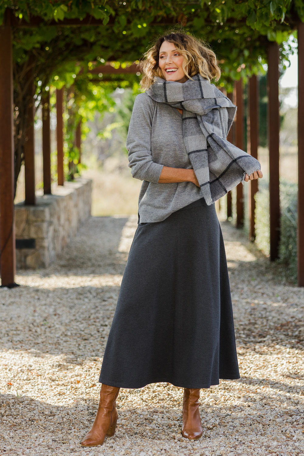 Model Emma wearing size 10 of The Fit And Flare Ponte Skirt in colour Greymarle (Grey), from the front, showing the whole outfit