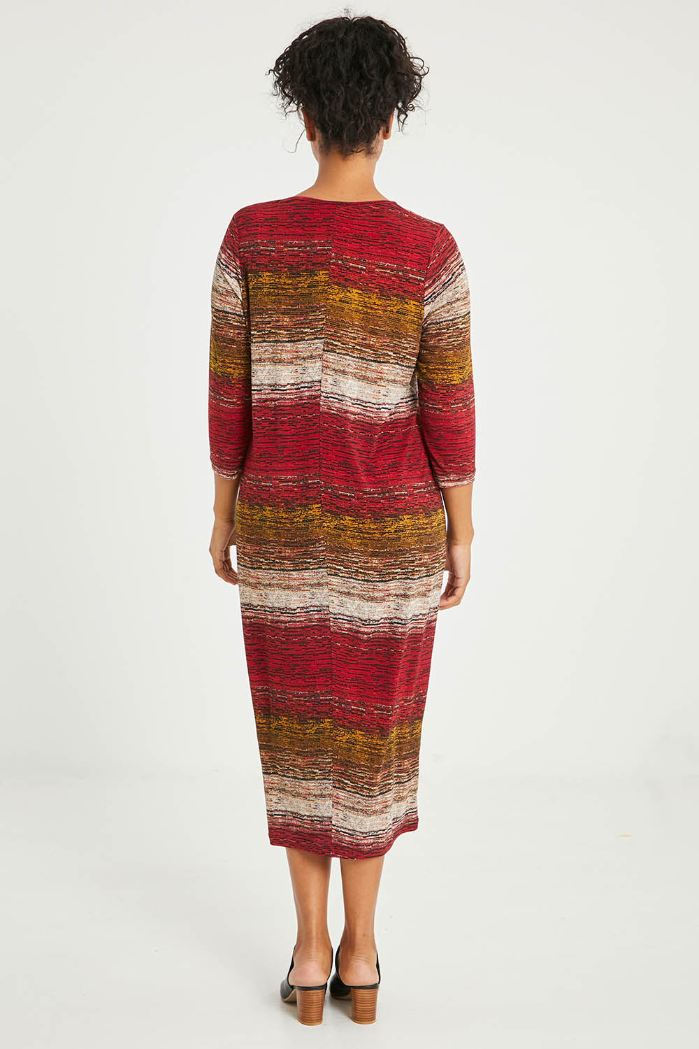 Model Noli wearing size 14 of The Print Everyday V Neck Dress in colour Multistrip (Red), from the back