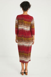Model Noli wearing size 14 of The Print Everyday V Neck Dress in colour Multistrip (Red), from the back