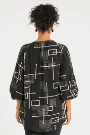 Model Noli wearing size 14 of The Keepers Printed Crew Neck Shirt in colour Blackivory (Black), from the back