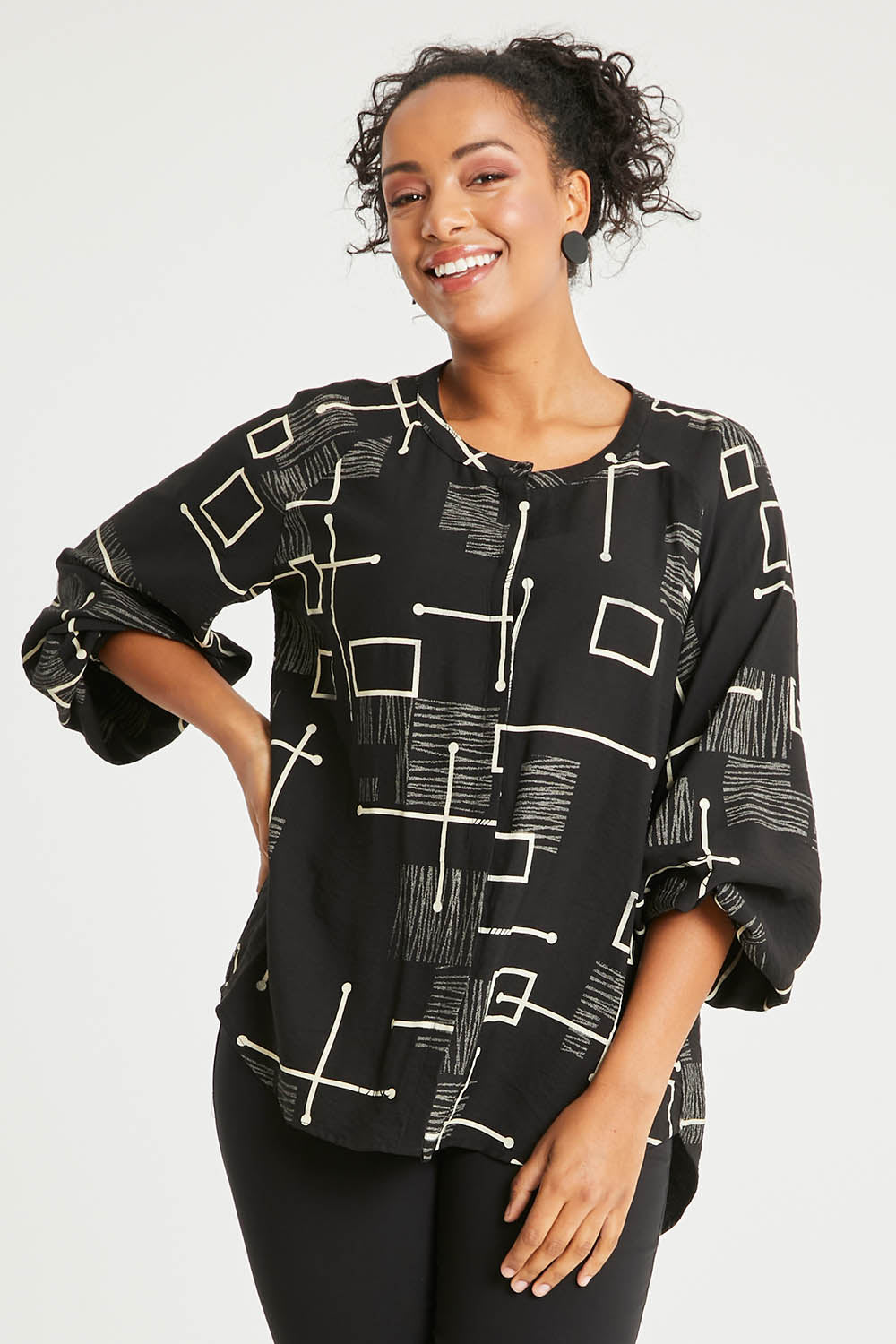 Model Noli wearing size 14 of The Keepers Printed Crew Neck Shirt in colour Blackivory (Black), from the front, cropped image