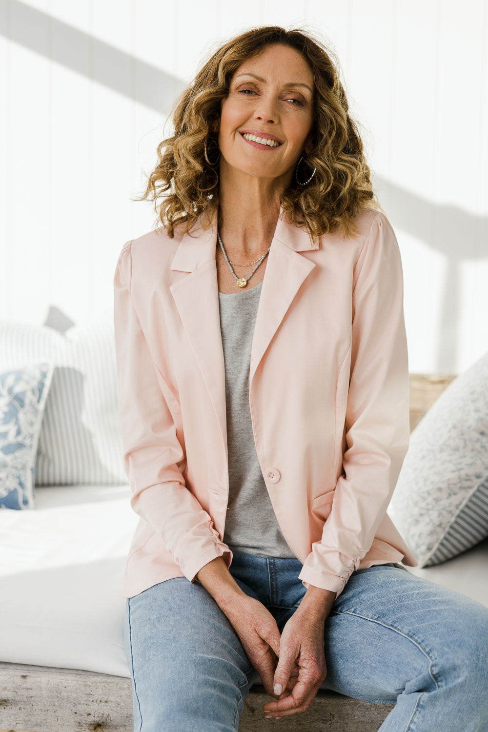 Model Emma wearing size 10 of The Everyday Long Sleeve Blazer in colour Blush (Pink), from the front, showing the whole outfit