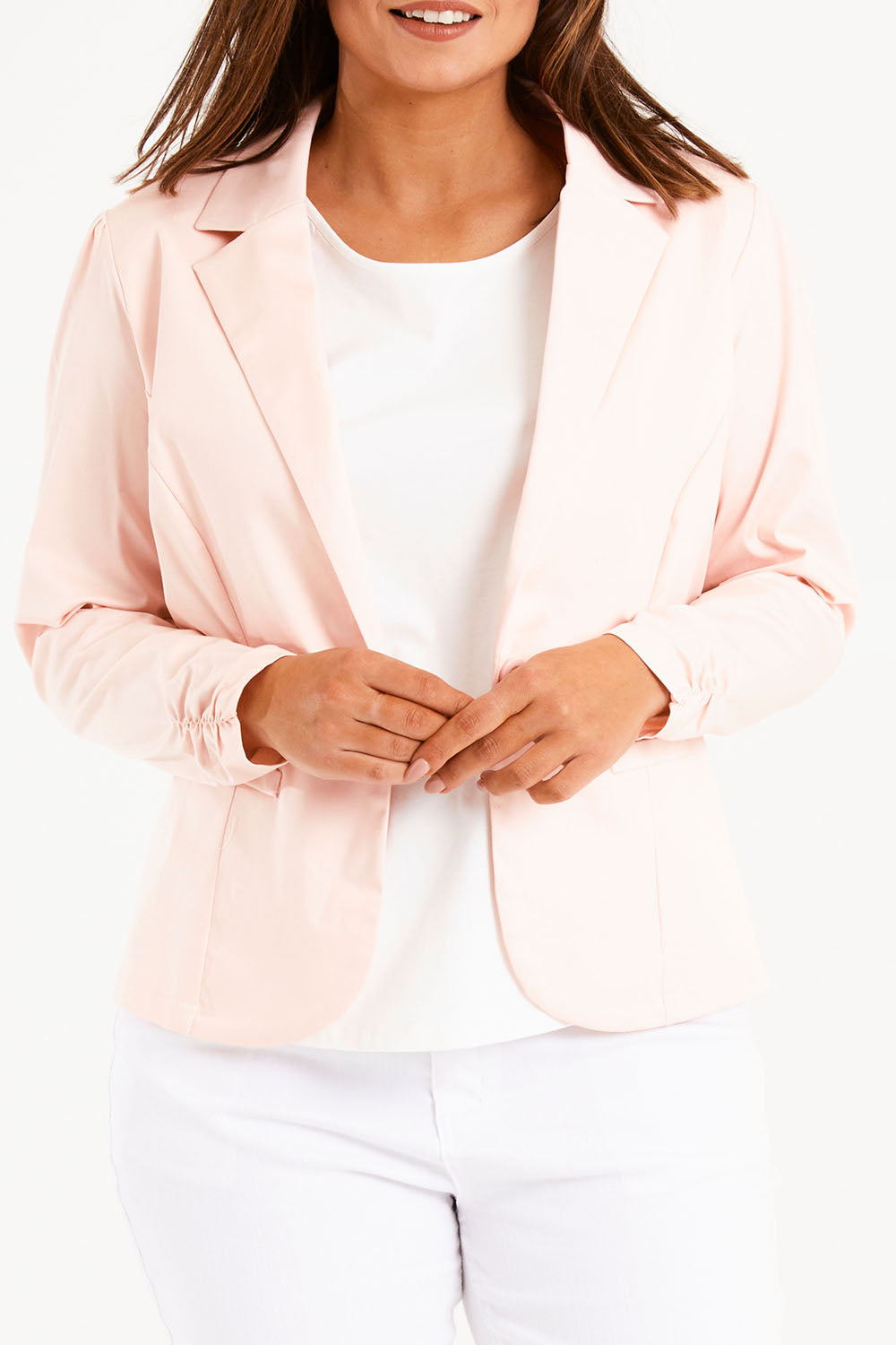 Model Monique wearing size 14 of The Everyday Long Sleeve Blazer in colour Blush (Pink), from the front, cropped image