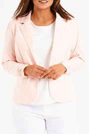 Model Monique wearing size 14 of The Everyday Long Sleeve Blazer in colour Blush (Pink), from the front, cropped image