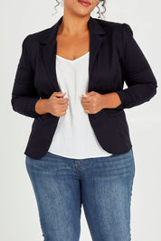 Model Alexis wearing size 16 of The Everyday Long Sleeve Blazer in colour Darknavy (Blue), from the front, cropped image
