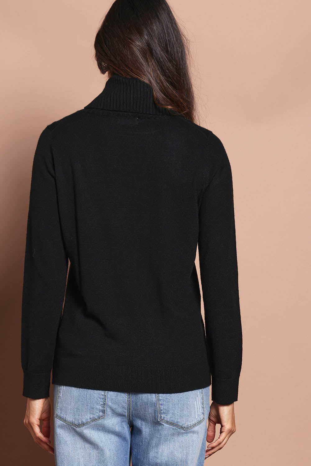 Model Amanda wearing size S of The Keepers Soft Roll Neck Jumper in colour Black (Black), from the back