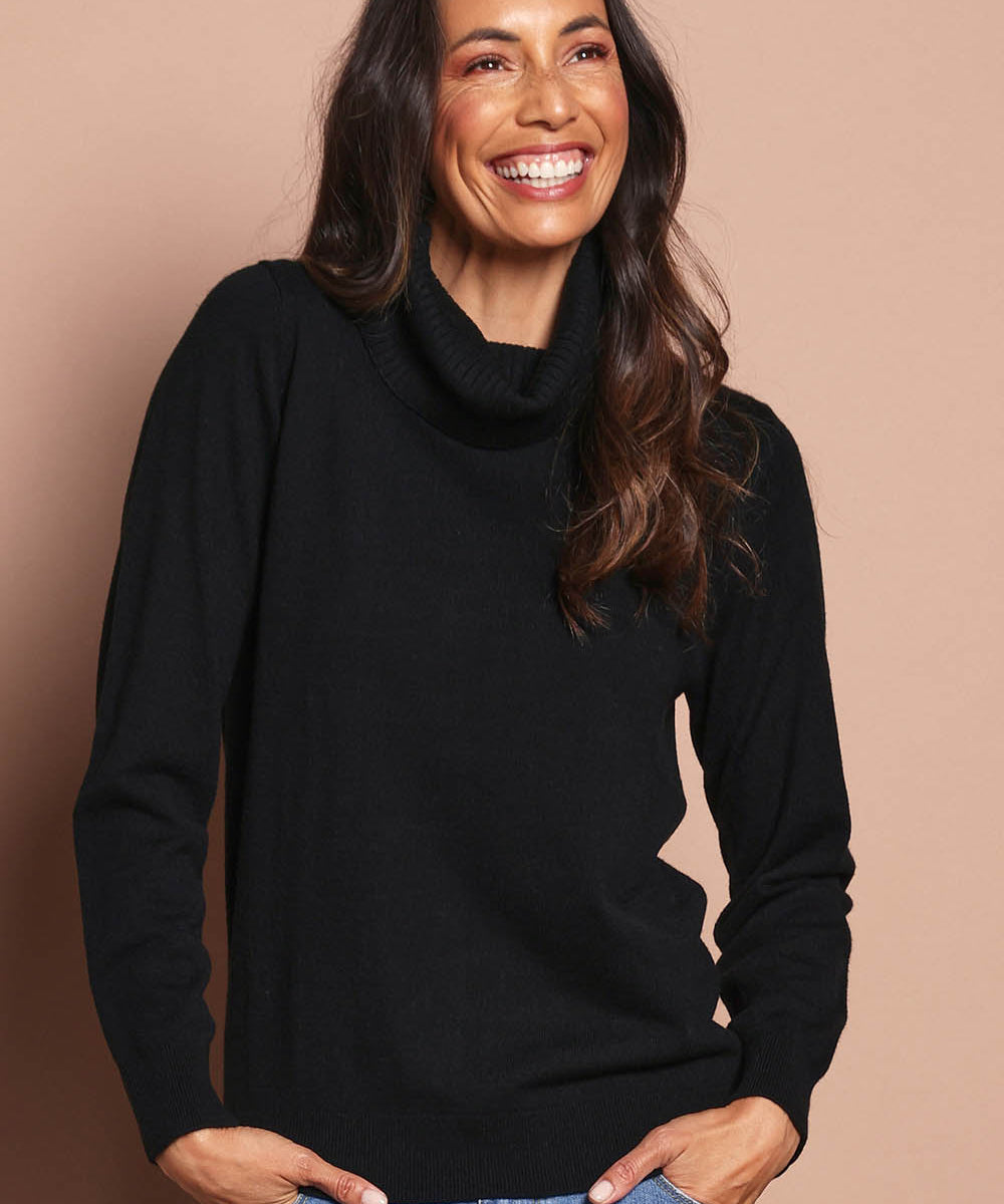 Model Amanda wearing size S of The Keepers Soft Roll Neck Jumper in colour Black (Black), from the front, cropped image