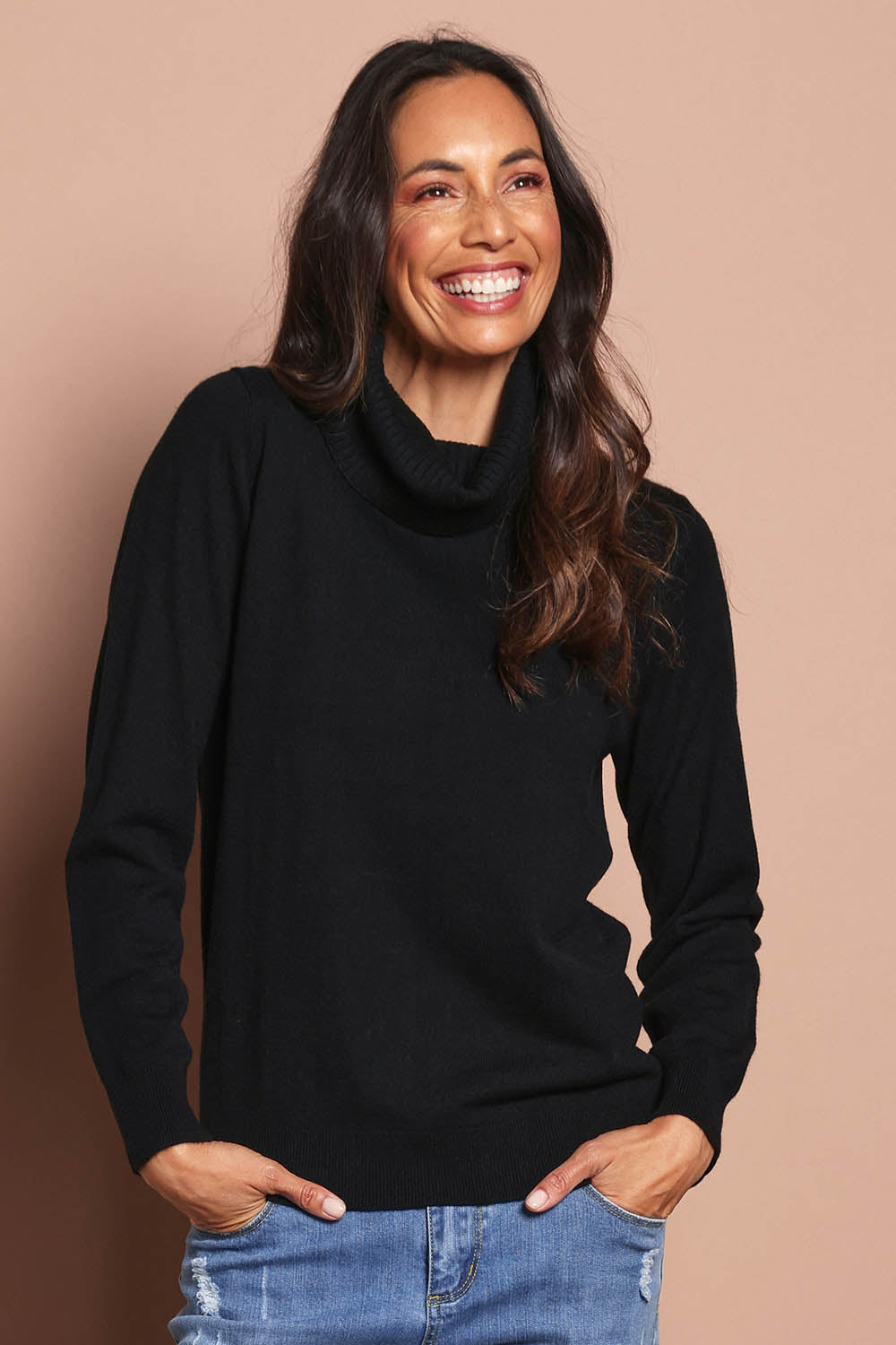 Model Amanda wearing size S of The Keepers Soft Roll Neck Jumper in colour Black (Black), from the front, cropped image