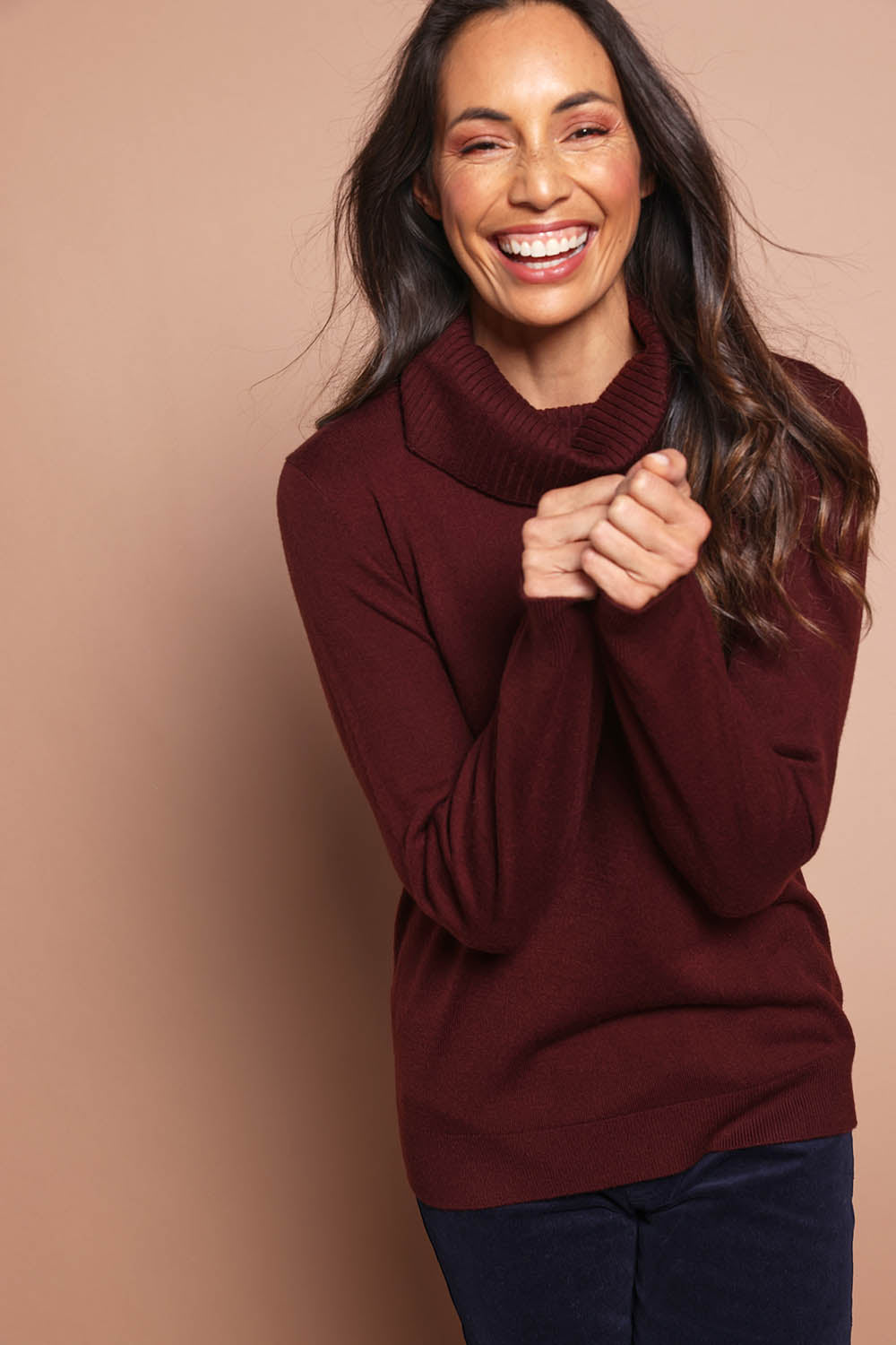Model Amanda wearing size S of The Keepers Soft Roll Neck Jumper in colour Burntplum (Purple), from the front, cropped image