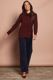 Model Amanda wearing size S of The Keepers Soft Roll Neck Jumper in colour Burntplum (Purple), from the front, showing the whole outfit