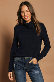Model Madeline wearing size S of The Keepers Soft Roll Neck Jumper in colour Darknavy (Blue), from the front, cropped image