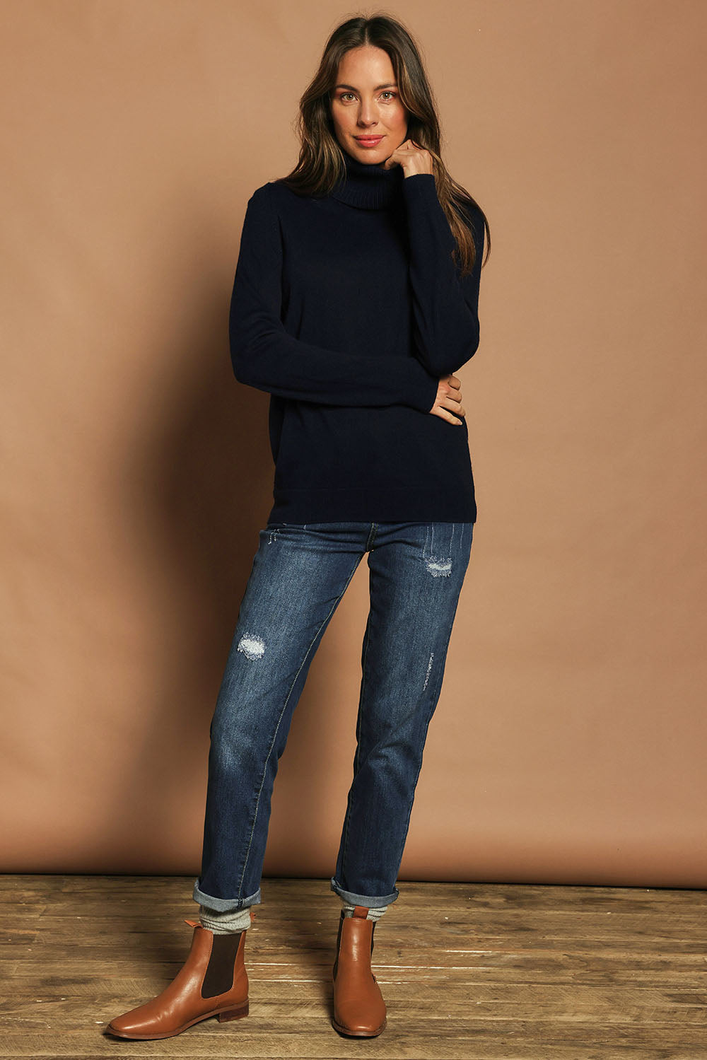 Model Madeline wearing size S of The Keepers Soft Roll Neck Jumper in colour Darknavy (Blue), from the front, showing the whole outfit