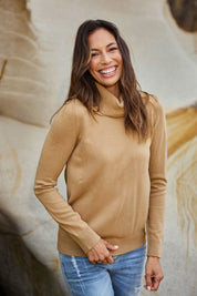 Model Amanda wearing size S of The Keepers Soft Roll Neck Jumper in colour Latte, from the front, showing the whole outfit