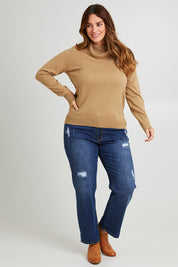 Model Laura wearing size L of The Keepers Soft Roll Neck Jumper in colour Latte, from the front, showing the whole outfit