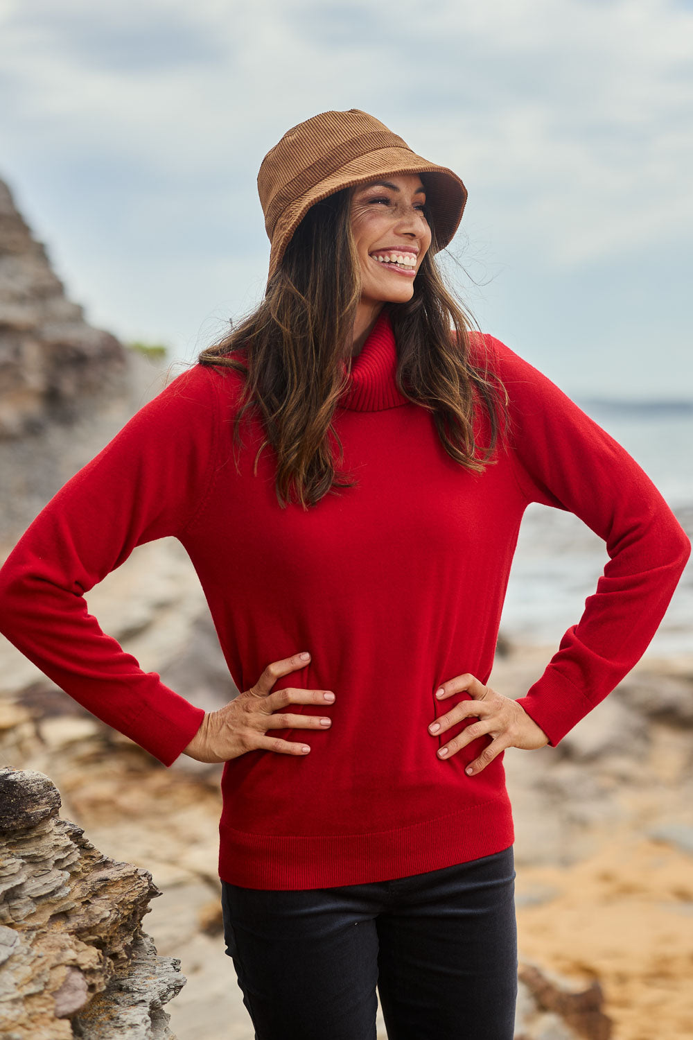 Model Amanda wearing size S of The Keepers Soft Roll Neck Jumper in colour Red (Red), from the front, showing the whole outfit