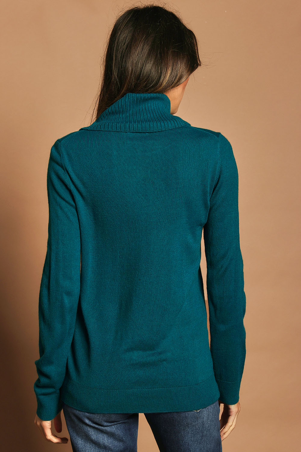 Model Madeline wearing size S of The Keepers Soft Roll Neck Jumper in colour Turquoise (Green), from the back
