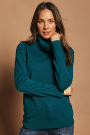 Model Madeline wearing size S of The Keepers Soft Roll Neck Jumper in colour Turquoise (Green), from the front, cropped image