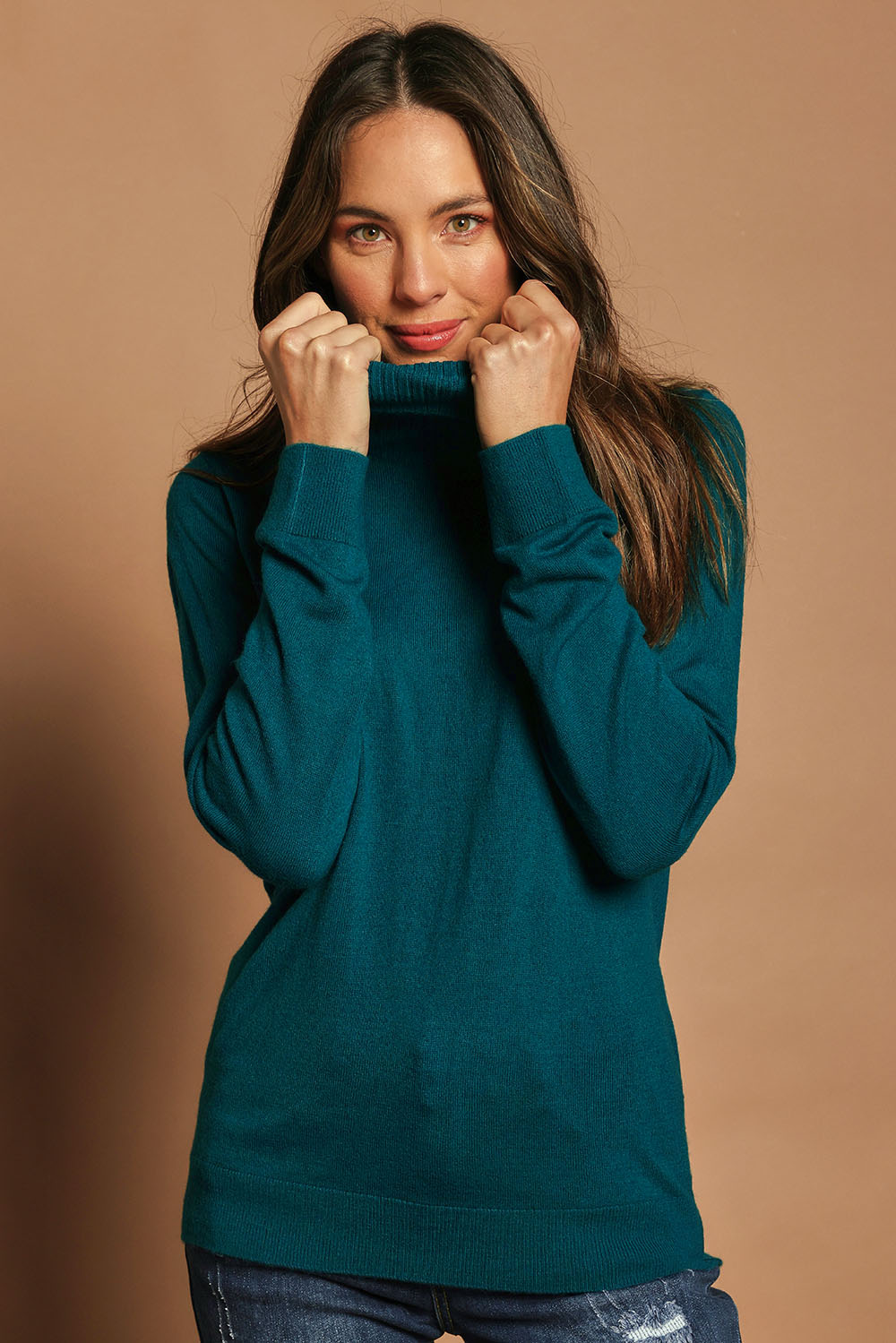 Model Madeline wearing size S of The Keepers Soft Roll Neck Jumper in colour Turquoise (Green), from the front, cropped image